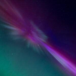 Vibrant Aurora Borealis over lake in Southwest Alaska