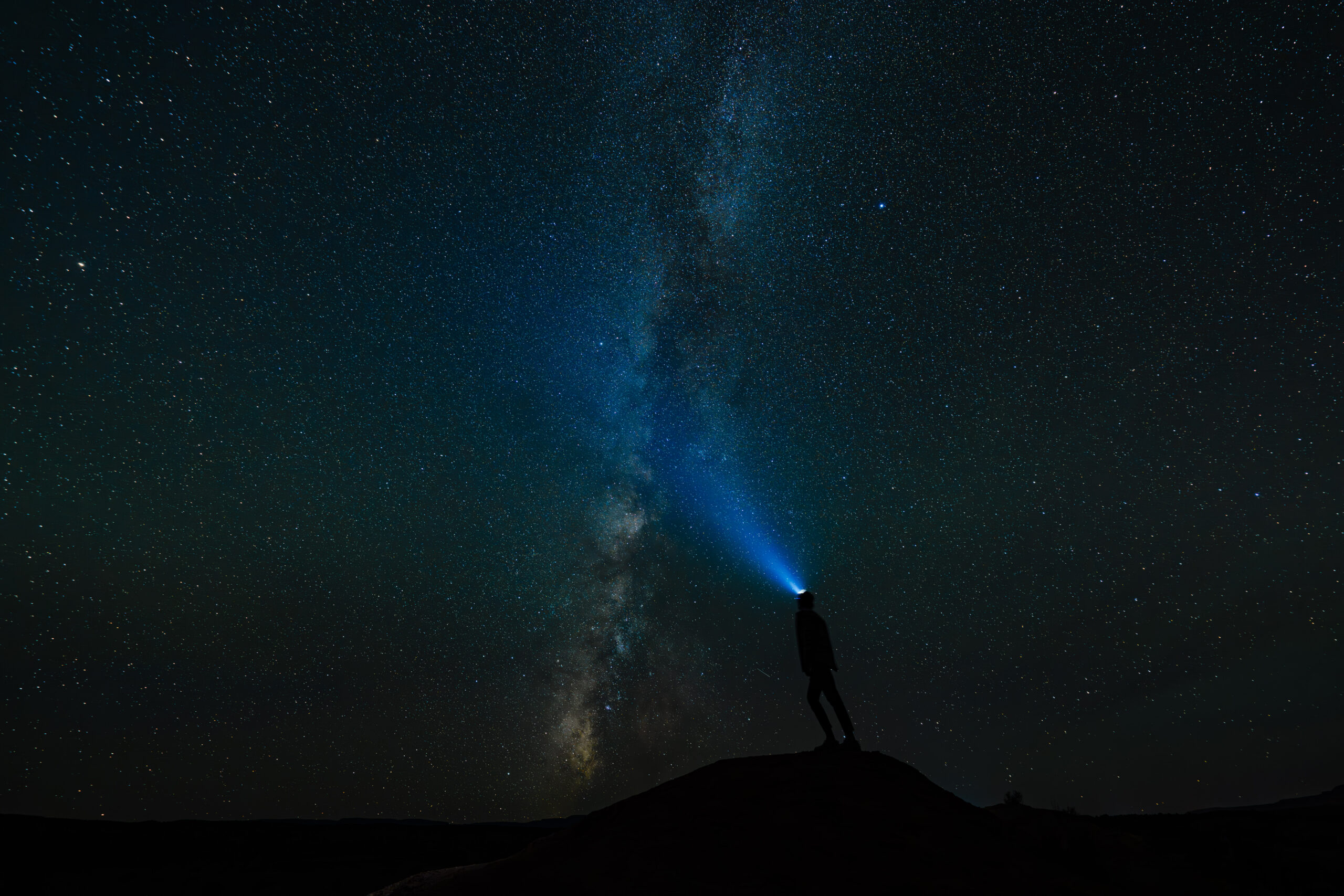 Looking up at the Milky Way with headlamp on during nighttime in Capitol Reef National Park in Utah