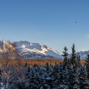 Plane flying low over the Chugach Mountain Range outside of Anchorage, Alaska