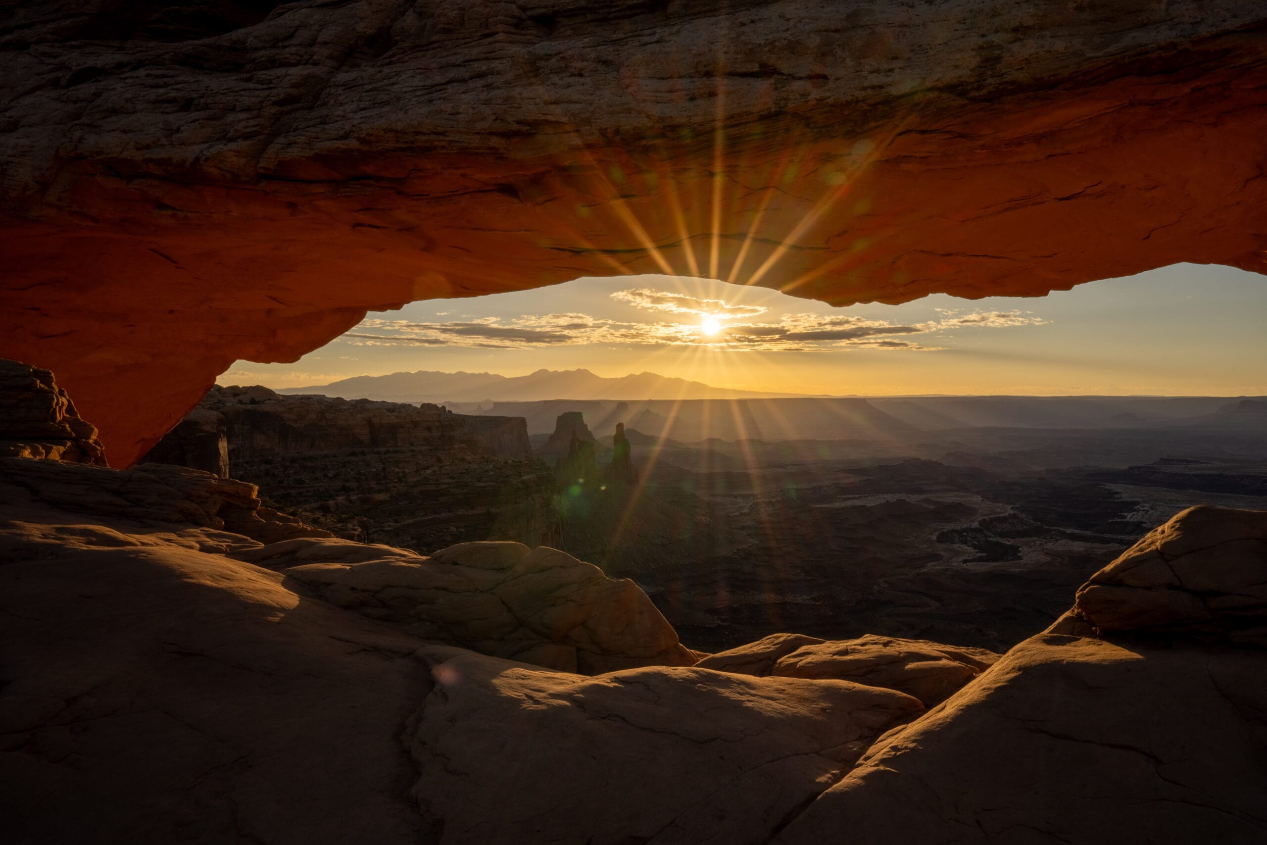 Sunrise shining through Mesa Arch in Canyonlands National Park located in Southern Utah
